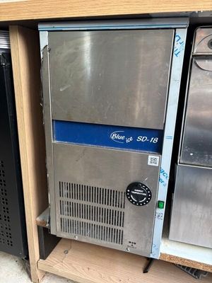 several stainless steel refrigerators are stacked on a shelf in a store