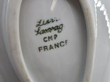 a close up of a white vase with writing on it