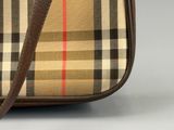 the small vintage check bag is sitting on the table