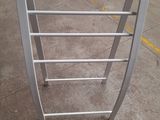 a metal rack that has a glass top on it