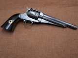 a gun that is laying on top of a brown cloth
