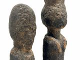 two stone statues that are standing next to each other
