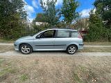 a picture of a silver car parked on the side of the road