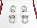 pair of silver buckles in a red box on a white surface