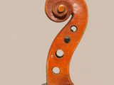 an old violin with a wooden back and a long neck