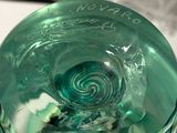 a close up of a glass with a swirl inside of it