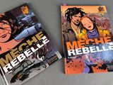 two books on a table one is a comic book and the other is a comic book
