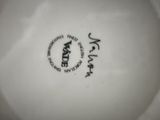 a close up of a white plate with a black and white design