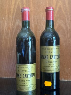 two bottles of wine sitting next to each other on a table