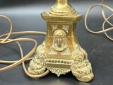 a gold lamp that is sitting on a table