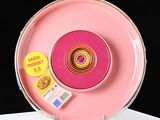 a pink object with a yellow sticker on it