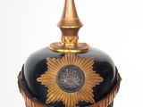 a black and gold hat with a gold star on it