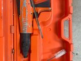 an orange tool box with a hammer and a brush in it