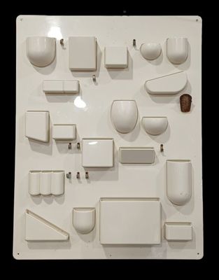 a picture of a white wall with a bunch of objects on it
