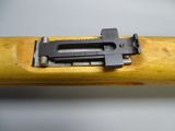 an image of a close up of a wooden stick with a metal clamp