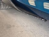 a close up of a car ' s rear end with a flat tire