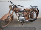 a brown motorcycle parked in front of a window