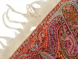 a close up of a colorful rug with fringes on it