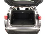 the back of a silver car with its trunk open on a white background