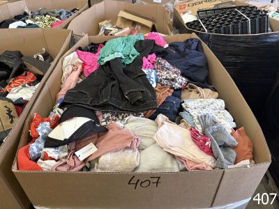 a cardboard box filled with clothes and other items