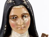 a statue of a woman with a cross in her hand