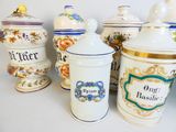 many different types of kitchen canisters on the table