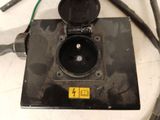 a picture of a black electrical outlet on a table