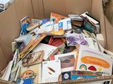 a cardboard box full of books in the middle of a store