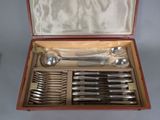 a wooden case with a set of silverware in it