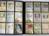 a lot of different pokemon cards in a blue folder