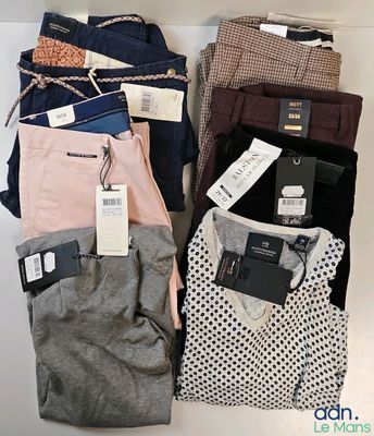 men ' s pants are stacked on top of each other in a pile