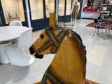 a wooden horse that is sitting in a room