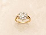 a close up of a diamond ring on a marble surface