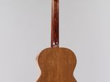 an image of a guitar hanging from a string on a wall
