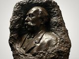 a bronze bust of a man with a beard and mustache