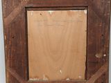 an old picture frame with a piece of wood in it