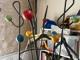 a metal sculpture of a bunch of balls on top of a stand