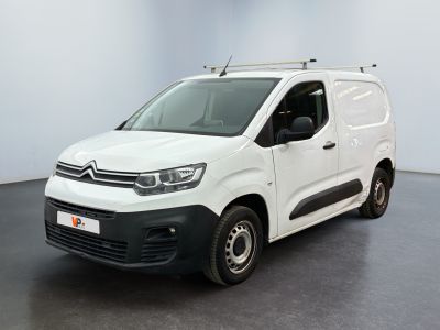 the white van is parked in a room with a black floor