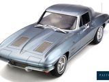 the car is blue and silver in color on a white background