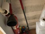 a picture of a bathroom with a toilet and a fire extinguisher