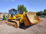 a picture of a bulldozer parked in a dirt lot