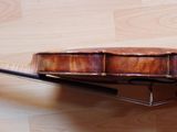 a violin that is sitting on a wooden floor
