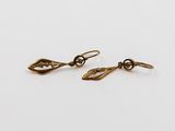 une paire de boucles d'oreilles en or sur fond blanc