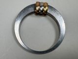 a silver ring with two gold beads on it