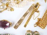 many different types of jewelry on a white surface