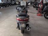 many motorcycles parked in a large room in a building