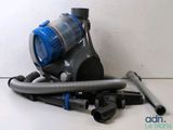 a vacuum that is sitting on the floor next to some hoses