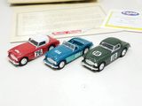 three toy cars sitting next to each other on a table