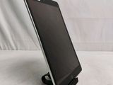 a tablet that is sitting on a stand on a table