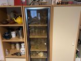 a glass door refrigerator in the corner of a room